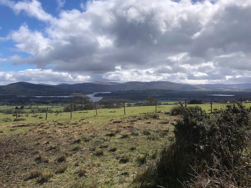 The view from Bishopshill Road: Poulaphouca reservoir with the Wicklow mountains in the background, underneath a partly blue, partly cloudy sky